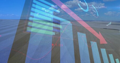 Displaying declining financial graphics over open flat landscape, with blue bars, red arrow, gauges