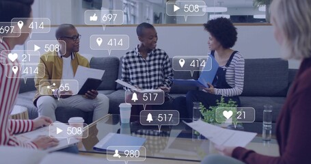 Discussing team in business clothes in office lounge at glass table with papers tablet overlays