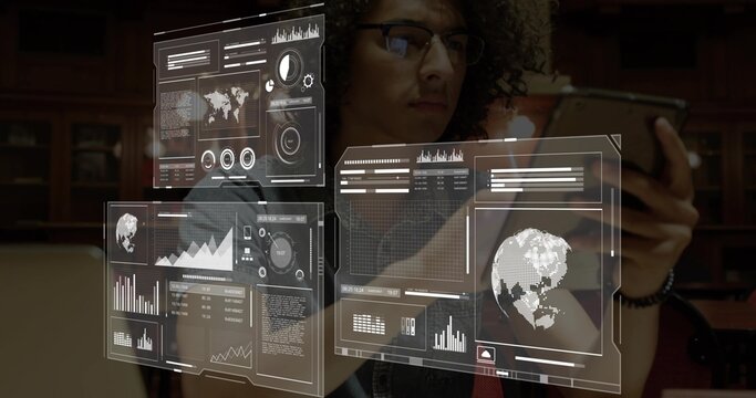 Holding smartphone, man wearing denim jacket and glasses studying at library table, with AR panels