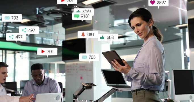 Leading woman in top with tablet guiding meeting at office with laptop floating badges, copy space - Powered by Adobe