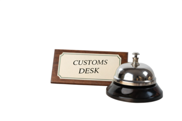 Customs Desk and Service Bell: A close-up view presents a classic metal service bell next to a sign, Customs Desk, symbolizing accessibility and assistance in the world of travel.