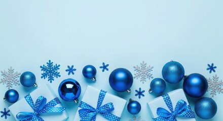 Blue christmas ornaments, snowflakes, and gifts on light blue background