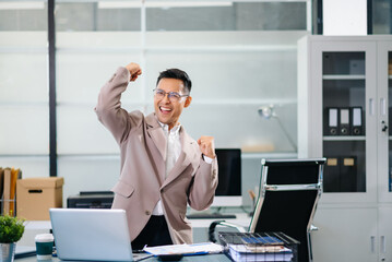 Cheerful businessman checking time feeling motivated waiting for leaving office do on their tablet, laptop and taking notes at office