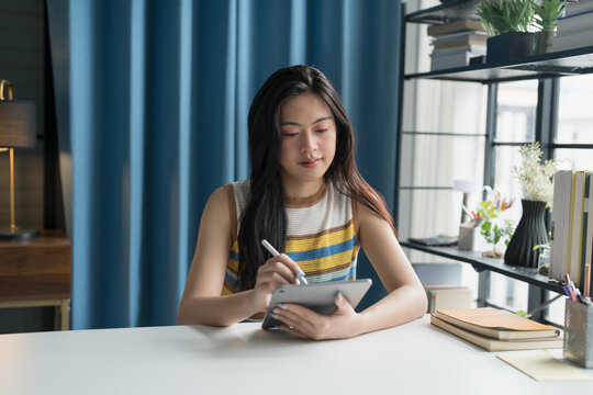 Asian woman Graphic designer working on digital tablet. artist drawing on graphic tablet female Artist Creative Designer sketch graphic drawing creative studying work