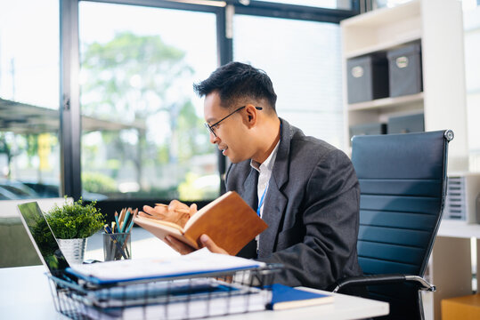 Mature business man executive manager looking at laptop watching online webinar training or having virtual meeting video conference doing market research - Powered by Adobe