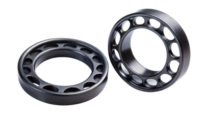 Two black ceramic ball bearing retainer cages isolated on transparent background