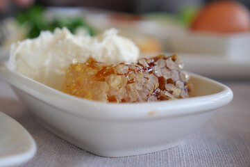 Delicious honey and cream served on a white plate