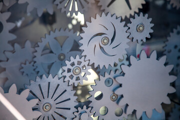Many different sized gears on a dark background