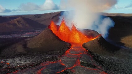 Lava erupts from volcano and flows down the landscape in Iceland during natural spectacle. Witness the breathtaking eruption of lava from a volcano in Iceland as it cascades down the rugged terrain in - Powered by Adobe
