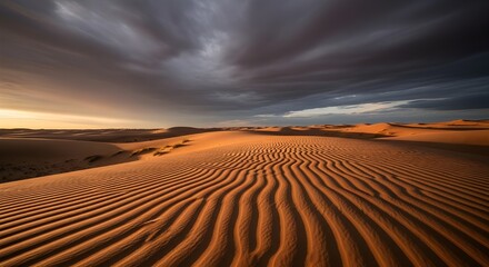 Naklejka premium Dramatic desert landscape with sand dunes and stormy sky at sunset