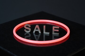 Illuminated sale ring on black surface