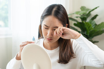 Health care concept, eye problem asian young woman applying, using medical eye drops to treat dry...