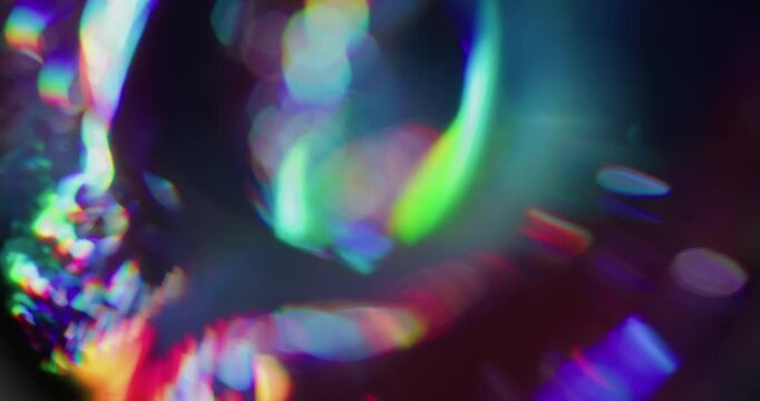Defocused diamond crystal. Holographic flare. Neon colorful luminosity on dark black background. Spectrum sphere spin bokeh effect.