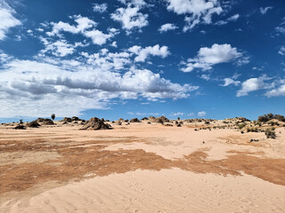 Eroded and weathered Walls of China in Mungo National Park Australia. A dry lake bed with eroded sand and sandstone under a beautiful cloudy sky