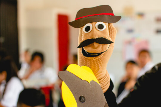 Hand puppet character teaching children in classroom