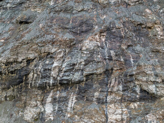 Rugged Rock Cliff Texture With Layered Strata and Weathered Stone Surface