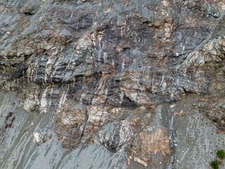 Rugged Rock Cliff Face With Layered Strata And Textured Stone Surface