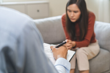 Psychology, depression. Suffer asian young woman consultation with psychologist while patient...