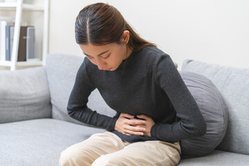 Flatulence ulcer, asian young woman, girl hands in belly, stomach pain from food poisoning,...