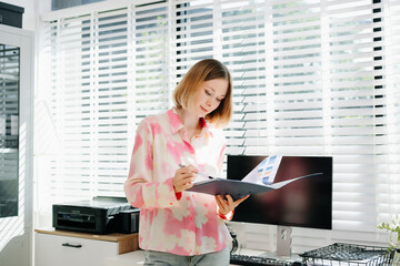 Business woman reviewing documents in a bright modern office. planning, and professional workplace concepts.