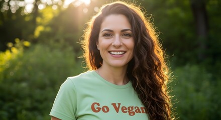 Happy woman smiling in a green t-shirt with a nature background