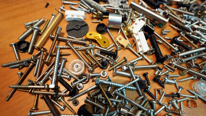 Close-up of silver metal nuts and bolts in industrial workshop