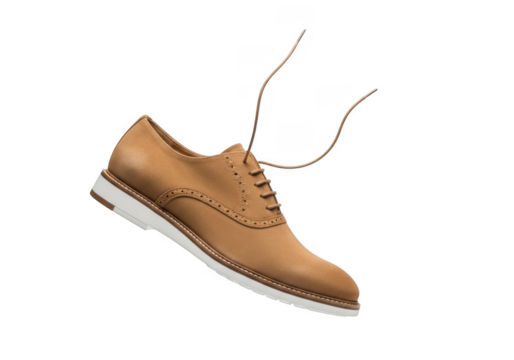 A tan suede oxford shoe with white sole isolated on transparent background