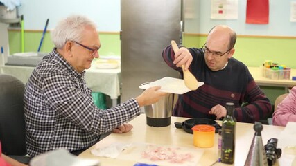 People with physical disabilities cooking together at home