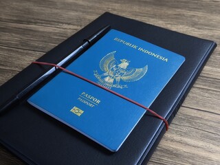 Close up view of an Indonesian passport on wooden table. Travel concept