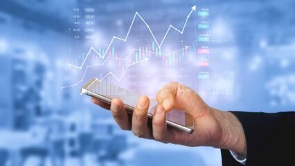 A businessperson engages with a smartphone displaying financial charts and graphs, showcasing modern analysis of market trends in a contemporary office environment. Scalp