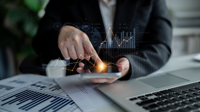 A business professional interacts with financial data on a smartphone, surrounded by charts and graphs, highlighting modern analytics and decision-making strategies. Scalp - Powered by Adobe
