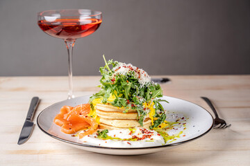 Brunch pancakes with salmon and greens