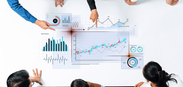 A diverse business team collaborates on data analysis by examining graphs and charts on a modern table. Their engagement highlights the importance of teamwork in data-driven decision-making. Trope