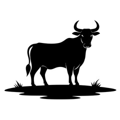 Majestic black silhouette of a standing bull on a grassy patch silhouette