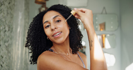 Skincare, portrait or woman in bathroom with oil pipette, hydration or vitamin C benefits in soft...