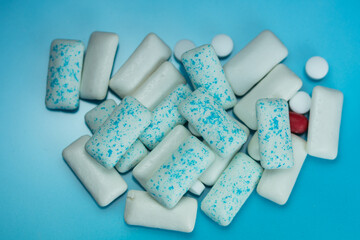 a pile of assorted chewing gum pieces in various shapes and colors. 