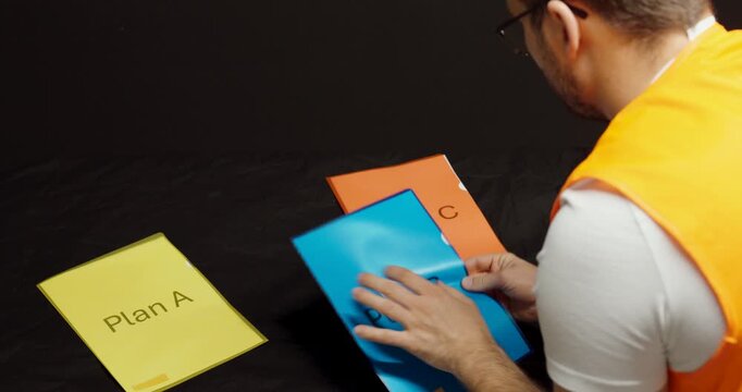 A worker confidently selects one of three plans labeled A, B, and C, representing decision-making and strategic planning in the workplace.