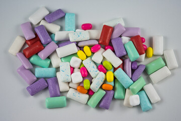 a pile of assorted chewing gum pieces in various shapes and colors. 