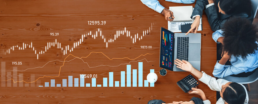 A diverse business team collaborates over financial data analysis, utilizing a laptop, charts, and graphs to discuss strategies and insights for growth. Scalp - Powered by Adobe