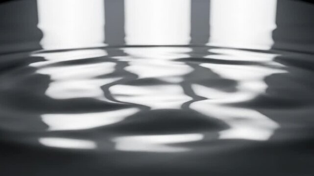 Ultra close-up slow motion shot of smooth silver liquid metal surface rippling and reflecting bright studio light creating beautiful caustic patterns backdrop, texture, metal