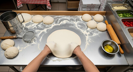 Skilled hands stretching fresh pizza dough preparing delicious Italian food on a professional restaurant kitchen counter with ingredients ready for baking