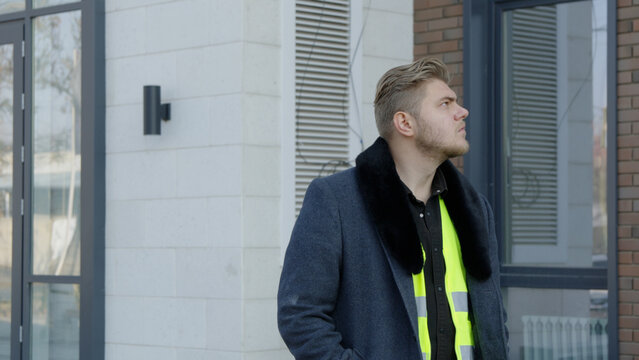 The site manager is inspecting the progress of the building construction