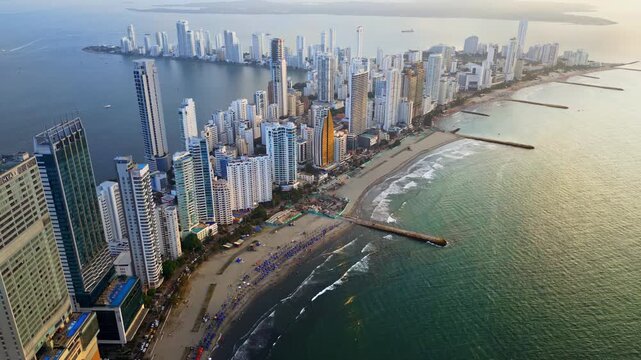 Aerial drone view of Cartagena's coastal skyline with beaches, residential towers, and the shimmering Caribbean Sea in the background