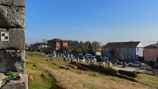 4K video of Prusias ad Hypium theater in Duzce. The ancient Roman ruins are nestled directly within the modern settlement of Konuralp, blending history with urban life.