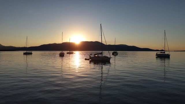 Kastos Island,Ionian Sea,Aerial view,Still Frame,Sailboats anchored in front of the island during sunset.