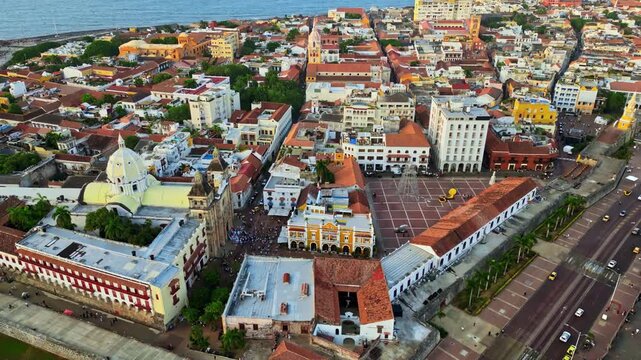 Aerial drone view of Cartagena's famous walled city, highlighting its colonial architecture, domed cathedral, and historic streets by the Caribbean Sea