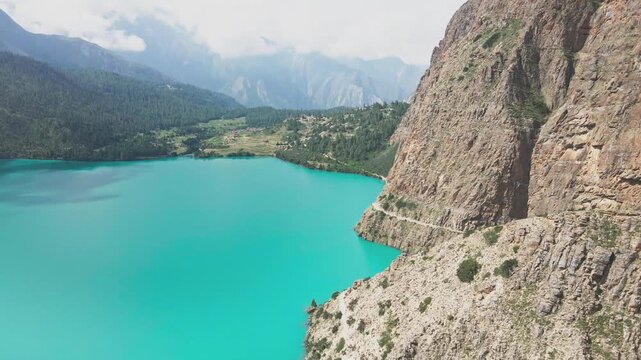 A drone glides above Shey Phoksundo Lake, revealing unreal turquoise water, steep Dolpa cliffs, and untouched Himalayan wilderness. This aerial moment captures Nepal&rsquo;s remote beauty in pure clarity.