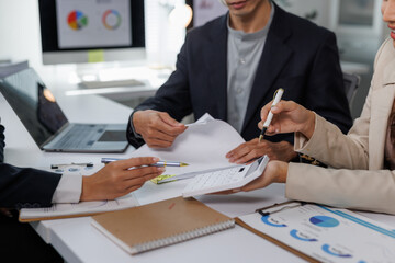 Business team analyzing financial data and planning strategy