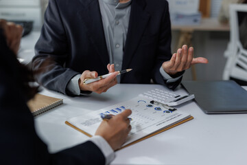 Business professionals analyzing financial growth data discussing strategy