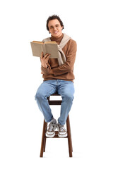 Young man reading book on white background